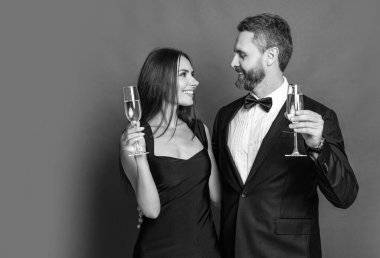 Yıldönümünü kutlayalım. Aşık çift nişanı kutluyor. Zarif çift kırmızıda izole edilmiş şampanya içer. Resmi olarak bir çift. Romantik randevu kutlamaları. Sevgililer Günü. Neşeli çift.