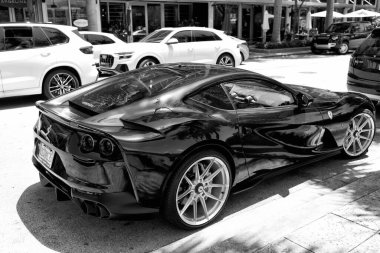 Miami Beach, Florida USA - April 15, 2021: black ferrari F12 berlinetta supercar, side corner view.