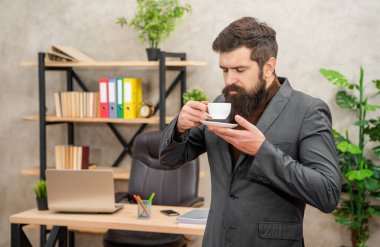 Ceketli, olgun girişimci sabah kahve molası vererek eğleniyor..