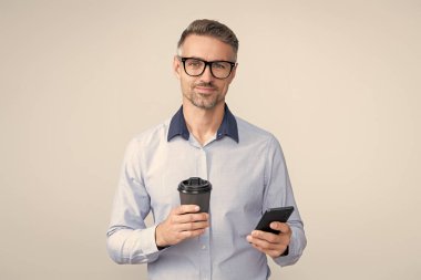 Telefon kullanan bir iş adamı. Gri yolda insan telefonu görüşmesi izole edildi. İş adamı sohbeti. İş adamı mesajlaşması ve mesajı. Sosyal ağ. Telefonu olan olgun bir iş adamı. Chatbot yardımı.