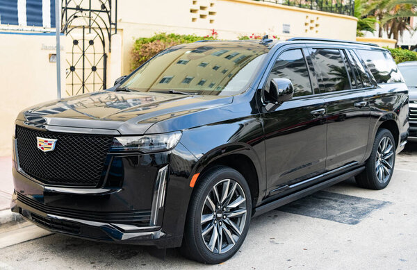 Miami, Florida, USA - April 04, 2025: Luxury sport car Cadillac Escalade ESV. Car Cadillac Escalade ESV parked outdoor. Black sportscar, corner view. 2023 Cadillac Escalade ESV Sport car.