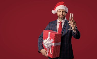 İşadamı, kırmızı üzerinde izole edilmiş Xmas 'ı kutluyor, kopyalama uzayı. Xmas işadamı kutlama yapıyor. Noel Baba şapkalı xmas işadamı. İş adamı bayramı kutluyor. Kutlama xmas.