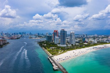 Miami sahil şeridinin hava gece görüşü. Miami Okyanusu 'nun üzerindeki alacakaranlık silueti. Miami Sahili kıyısı gün batımından sonra parlıyordu. Günbatımında South Point cankurtaran kulesi. Gökten ünlü Miami Sahili