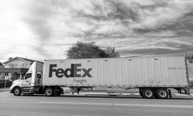 Chicago, ABD - 21 Ağustos 2024: Yolda FedEx konteynırlı kamyon. FedEx Şirketi, uluslararası kapsamı olan ABD merkezli bir lojistik şirketi. Federal Express teslimat işinde lider şirkettir..