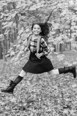 Bilgi ve eğitim. Okul eğitimi. Öğrenci hayatı. Okula dönelim. Sonbahar kızının okul çantası var. Ergenlik için eğitim. Sonbahar parkında açık havada genç bir kız. Çalışmak için sonbahar zamanı. Zıplayan öğrenci.