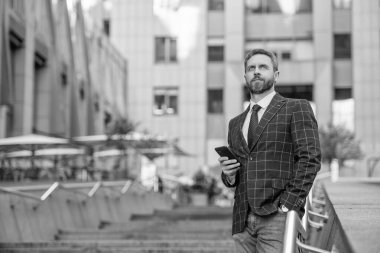 Telefon kullanan bir iş adamı. Şehirdeki erkek telefon konuşmaları. İş adamı telefonda konuşuyor. İş adamı ön ofiste. Sosyal ağ. Ofis binasında telefonu olan İspanyol bir iş adamı. Boşluğu kopyala.