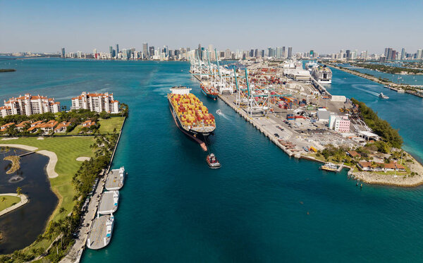 Miami, Florida, USA - April 12, 2025: MSC Susanna container ship. Cargo ship with container in Miami, aerial view. Freight container on cargo vessel. Cargo ship vessel leaving port. Port of Miami.