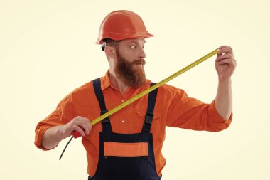 mezura. İnşaat mühendisi şok oldu. Mimar işçi, mezura tutuyor. Sakallı inşaat işçisi. İnşaatçı beyazda izole edilmiş. İnşaat mühendisi. Mimar ölçüm boyutu.