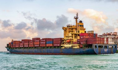 Miami, Florida, ABD - 16 Aralık 2024: konteyner gemisi. Yük Chloe D Monrovia gemisi, konteynır, insansız hava aracı görüşlü. Kargo gemisinde nakliye konteynırı. Kargo gemisi. Gün batımında Miami Limanı.