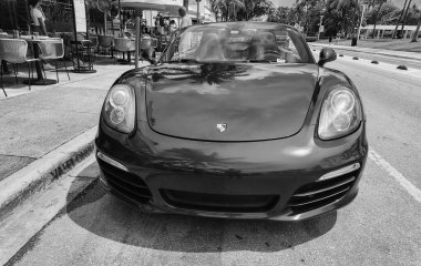 Miami Beach, Florida USA - 8 Haziran 2024: 2018 Porsche 718 Boxter mavisi Miami sahilinde. Ocean 'daki lüks araba porshche' si Miami plajına gidiyor. ön görünüm
