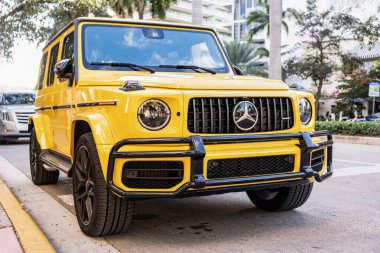 Miami, Florida, ABD - 26 Ocak 2025: Mercedes Benz hibrit araba açık havada park edildi. Sarı araba, köşe manzaralı. 2025 Mercedes Benz G sınıfı hibrit araba. Lüks elektrikli ve motorlu Mercedes Benz G sınıfı..