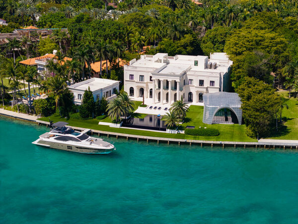 Vacation in summer. Luxury waterfront hotel building. Summer vacation. Landscape with luxury residential area. Residential waterfront apartment with docked boat. Waterfront landscape with house.