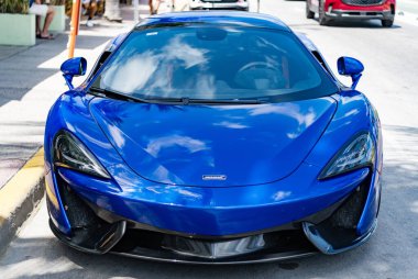 Miami, Florida, ABD - 19 Nisan 2025: Car McLaren 570 açık hava parkı. Mavi spor araba, ön manzara. 2018 McLaren 570 S spor araba. Lüks spor araba McLaren 570 'ler..