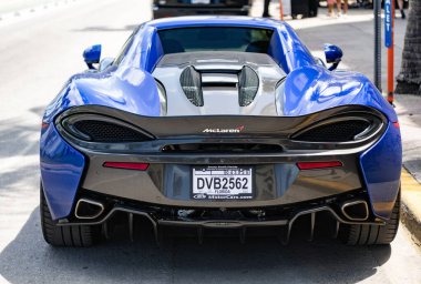 Miami, Florida, ABD - 19 Nisan 2025: Car McLaren 570 açık hava parkı. Mavi spor araba, dikiz aynası. 2018 McLaren 570 S spor araba. Lüks spor araba McLaren 570 'ler..