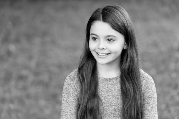 Trendy stylish teenager girl smiling. Fall fashion style for teen. Complete outfit style. Girl portrait in casual sweater. Long brunette hair. Teen girl with long hair outdoor. Autumn fashion girl.