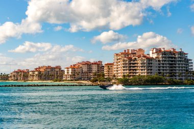 Teknesi olan Miami Kanalı. Fisher Adası konut binası ve lüks yat teknesi. Miami Fisher Adası 'nın manzarası. Marinaya yüzen bir tekne. Fisher Adası 'nda lüks bir yat teknesi. Yaz tatili.