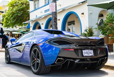 Miami, Florida, ABD - 19 Nisan 2025: Car McLaren 570 açık hava parkı. Mavi spor araba, dikiz aynası. 2018 McLaren 570 S spor araba. Lüks spor araba McLaren 570 'ler..