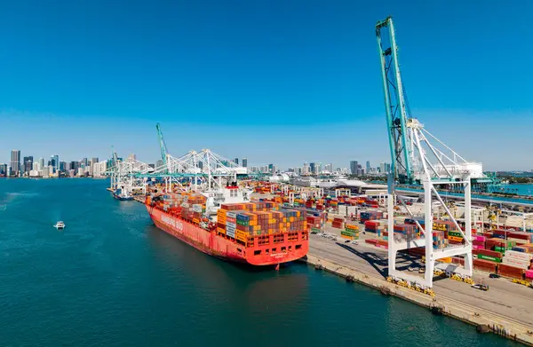 Miami, Florida, ABD - 20 Mart 2025: Kargo Hamburg Sud konteynır hizmetleri Miami 'de, hava manzaralı. Kargo gemisinde nakliye konteynırı. Kargo gemisi. Miami limanı. Konteyner gemisi.