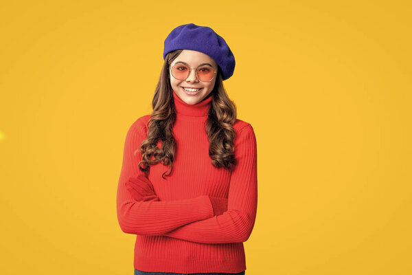 Trendy and stylish teenager girl smiling. Fall style teen. Trendy portrait of fall style. Girl in autumn jumper isolated yellow. Teen girl wear sunglasses. Autumn fashion girl. Effortless elegance.