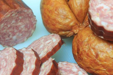 two types of sausages on a white cutting board, macro.