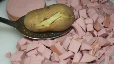 the hand of the cook checks with a toothpick boiled potatoes in their skins.