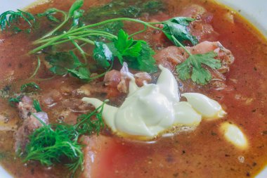 plate with red borscht and mayonnaise.