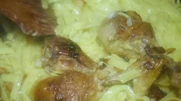 Spoon Stirs Appetizing Chicken Drumsticks Crust Noodles Top View — Stockvideo