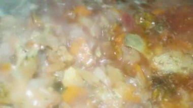 spoon stirs red borscht with meat, a popular dish in Ukraine, Moldova and Russia.