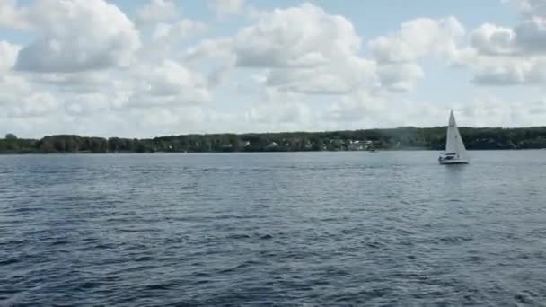 Pohled Moře Plovoucí Jediné Plachetnice Pobřeží Stromy Obloha Mraky — Stock video