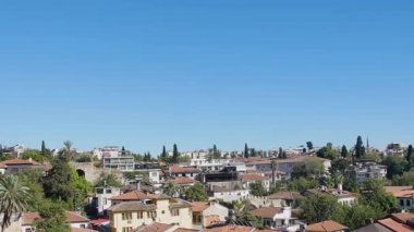  A steady, composed shot that highlights the Seljuk architecture of the Yivliminare as it rises from the dense urban fabric.