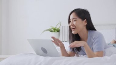 Young asian woman using laptop computer for video conference online with friends, businesswoman working with video call for meeting with social network, business and communication concept.