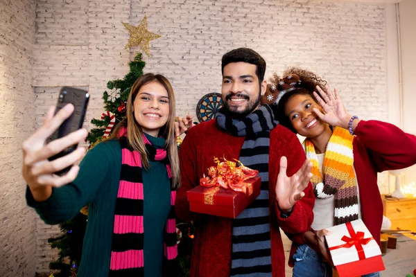 stock image Group young friends taking selfie with excited and enjoy with smart phone together at home, man and woman taking a photo in celebration xmas eve with cheerful, x-mas and new year or holiday concept.