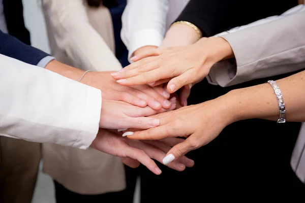 Group of business team harmonious with man and woman joining hands stack together in enterprise for victory and success, teamwork of partnership with meeting and cheering for achievement.
