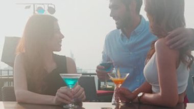 Grup arkadaşları birlikte kutlama yapmak için restorandaki partide kokteyl ve neşe içerek, kadın ve erkek buluşmaları ve içki içmeleri, yaşam tarzları konsepti..