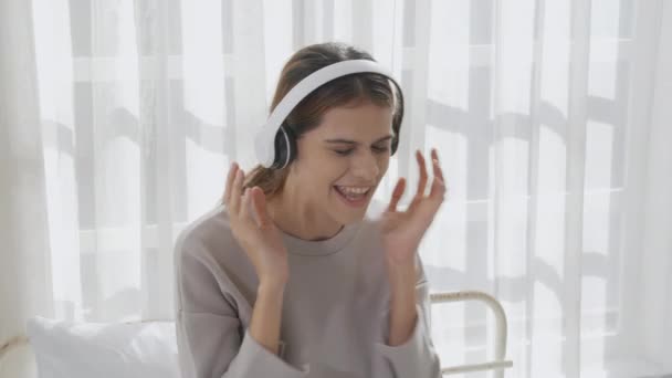 Happy Young Woman Wearing Headphones Listening Music While Dancing Singing — Vídeo de stock