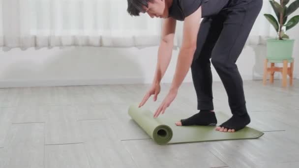 Young Asian Man Rolling Mat Yoga Floor Preparation Meditation Exercise — Stok video