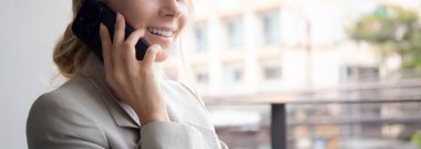 Beautiful young caucasian businesswoman sitting and talking on smartphone with relax in the office, business woman relax speaking on smart phone with confident, one person, communication concept.