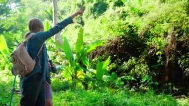 Teenager girl and two grandmother traveling travel to forest and adventure while using binoculars exploration together with happy, senior woman and granddaughter hiking with fun and vitality.