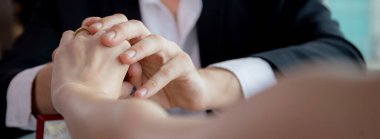 Hands of young couple date with romance together in anniversary at restaurant luxury for celebrate, man proposal woman for marriage while dining in atmosphere romantic, two people, valentine concept.