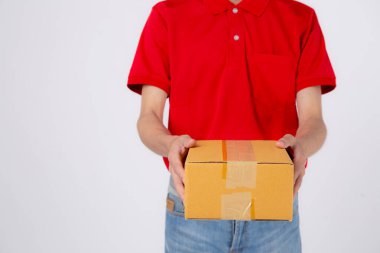 Young asian man in uniform red and cap standing carrying box stack isolated white background, employee holding cargo or package, courier and delivery, transportation and service, logistic and cargo.