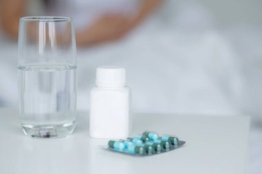 Genç Asyalı bir kadın yatak odasında hasta ve adet ve mide ağrısı, tıbbi ve sağlık konsepti, mide ağrısı, mide ağrısı, bağırsak ya da hastalıklı kabızlık veya hazımsızlık ile evde oturuyor..