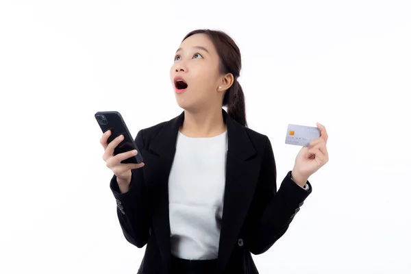 stock image Portrait young asian business woman hold credit card and looking smart phone for shopping online isolated white background, businesswoman looking debit card and smartphone, financial concept.