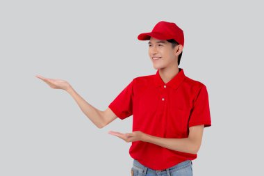 Young asian man in uniform red and cap standing presenting with excited isolated on white background, employee or dealer show, courier and delivery, deliveryman and expression, logistic and cargo.