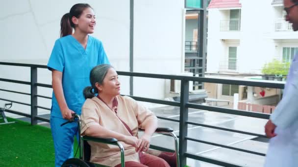 Caregiver Asian Woman Doctor Care Elderly Sitting Wheelchair Consoling Encourage — Stock Video