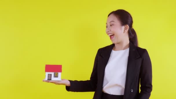 Portrait Young Asian Businesswoman Holding House Mortgage Loan Yellow Background — Stock Video