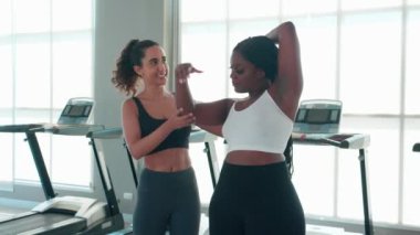 Spor salonunda ısınan ve kaslarını esneten antrenman yapan antrenör ya da eğitmen kadın spor salonunda spor yapan kadın spor antrenörü, spor ve sağlık motivasyonu ile spor yapıyor..