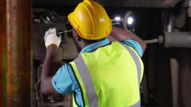 Genç siyah mühendis bakım ve onarım treni dizel motoru istasyonda, mühendis sistem ulaşımını denetliyor, teknisyen altyapıyı, ulaşımı ve sanayiyi kontrol ediyor, müfettiş ve ulaşım.