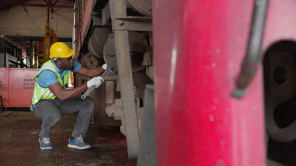 Young black engineer maintenance and repair train diesel engine in station, engineer inspect system transport, technician checking infrastructure, transportation and industry, inspector and transport.