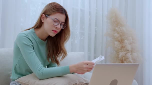 Young Asian Woman Wearing Glasses Sitting Sofa Worried Bills Financial — Stock Video