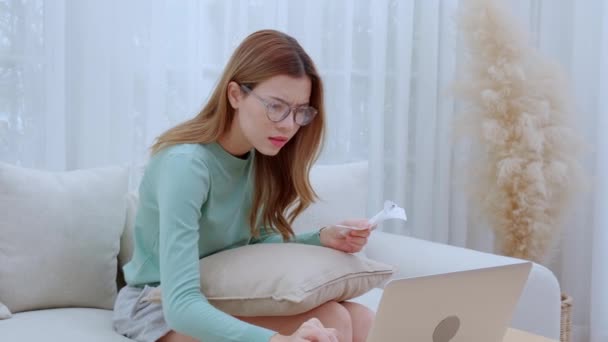 Young Asian Woman Wearing Glasses Sitting Sofa Worried Bills Financial — Stock Video
